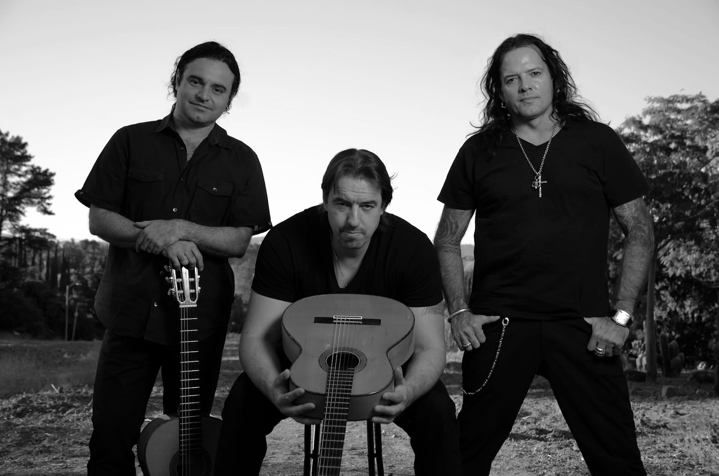 Calé — three guitarists with Spanish guitars, black and white